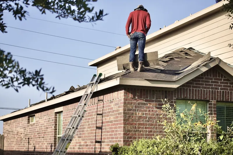 Professional roofer working on a residential roof in Sours Mills